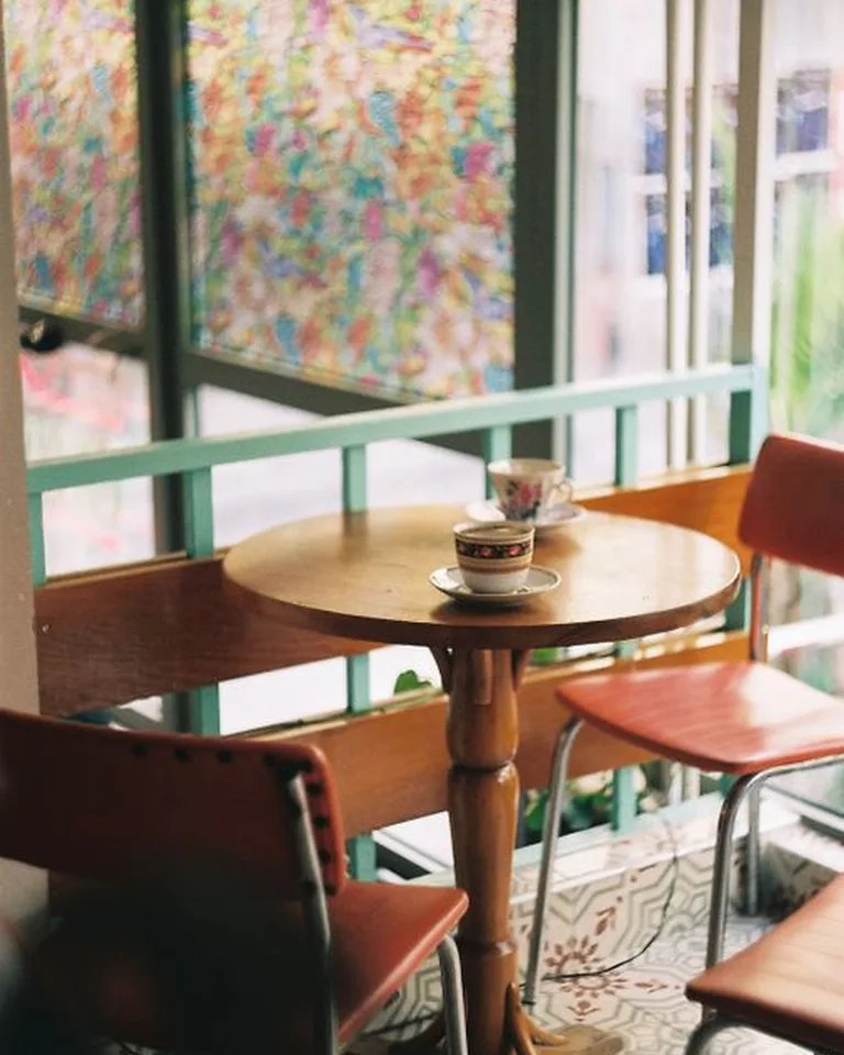 Bright corner coffee nook with a small plant beside the brewer