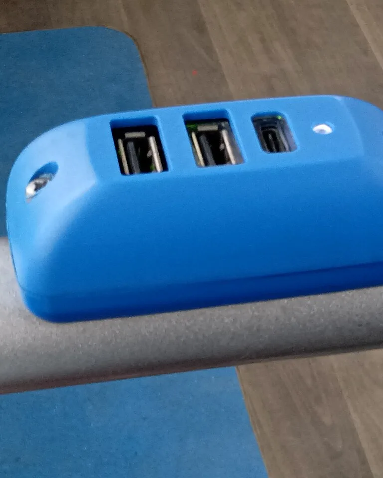 Smartphone charging on a small kitchen shelf