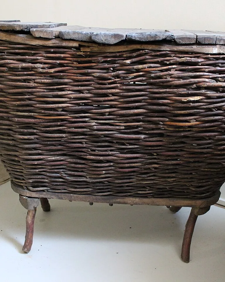 Woven storage baskets on shelves holding seasonal gear