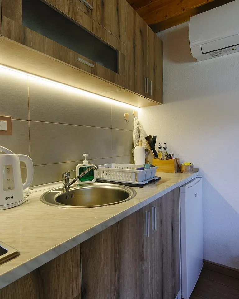 Kitchen with warm wooden cabinets showing how natural wood tones pair with mixed metal finishes