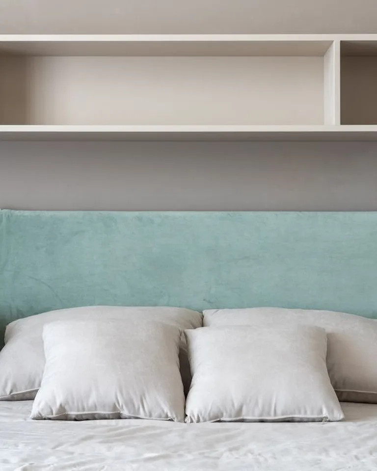 A bedroom headboard wall with built-in storage shelves on both sides