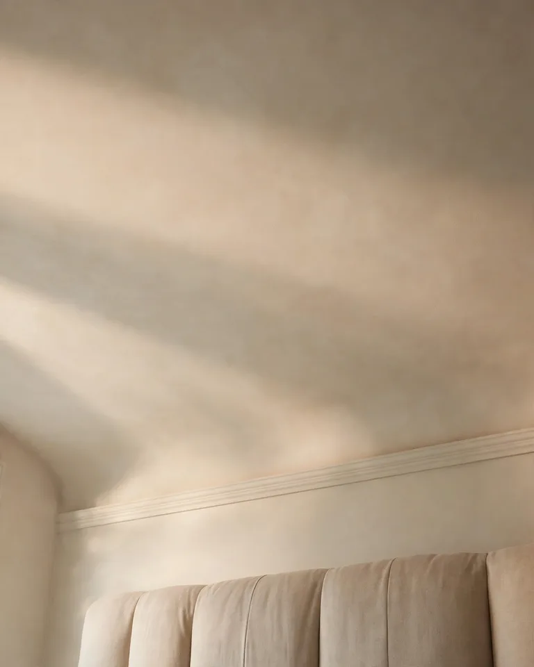 Close view of a bedroom ceiling painted a soft tint, showing the finished fifth-wall detail