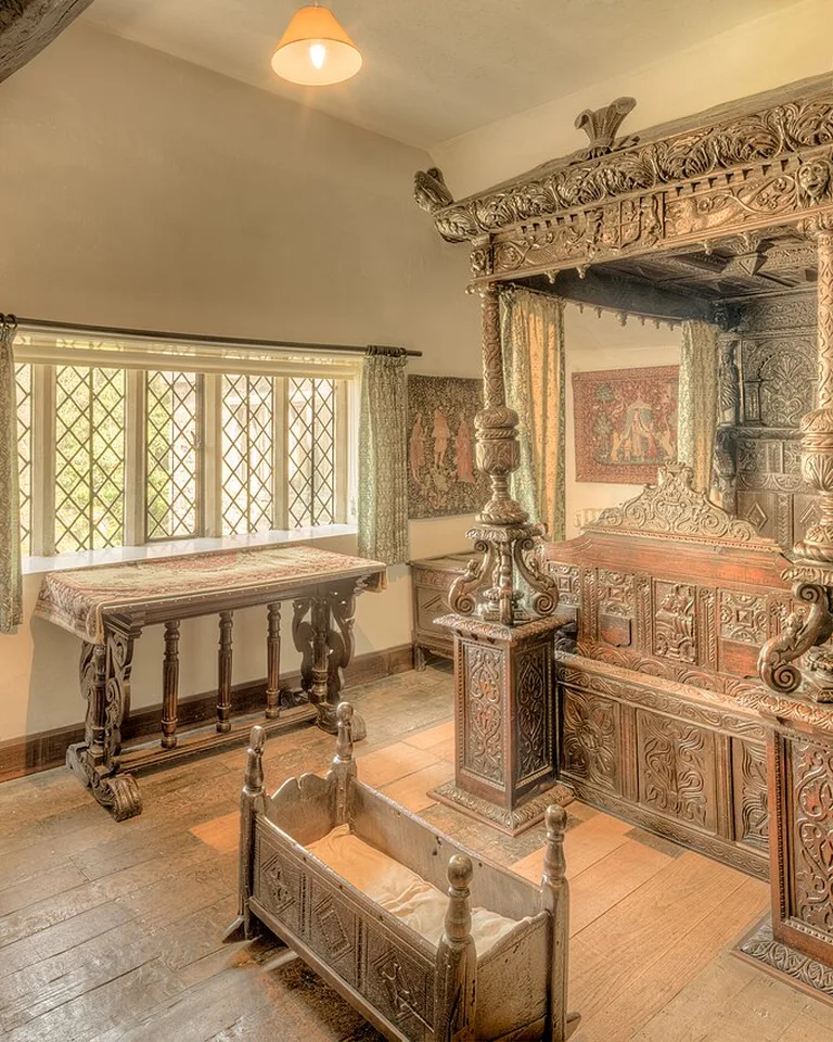 Historic carved-wood four-poster bedroom interior