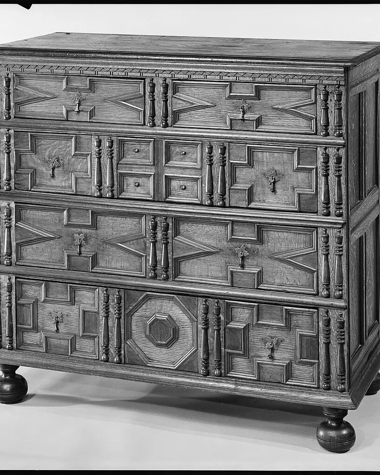 Tall narrow dresser in a bedroom