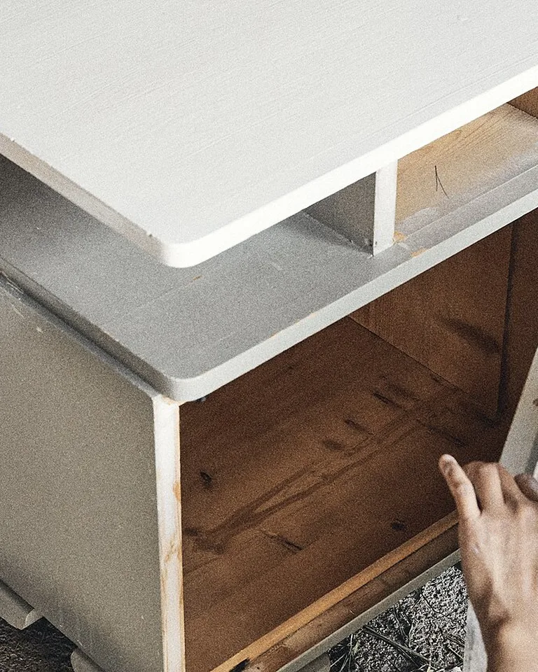 Small bedside table beside a bed
