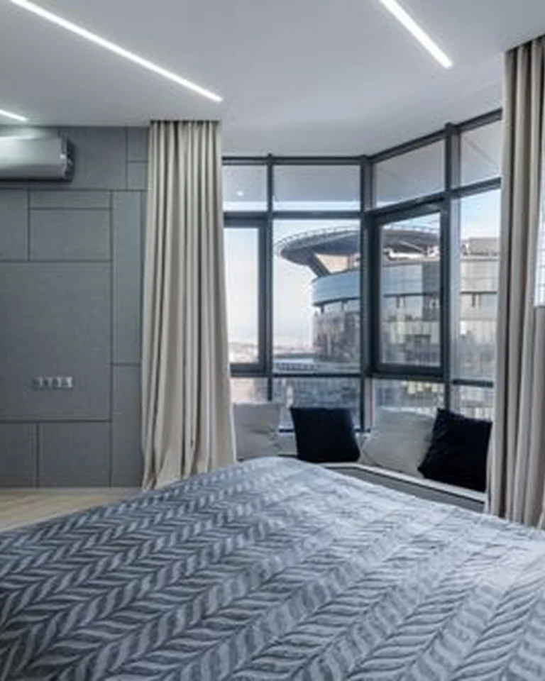 Bedroom curtains hung from a rod mounted near the ceiling