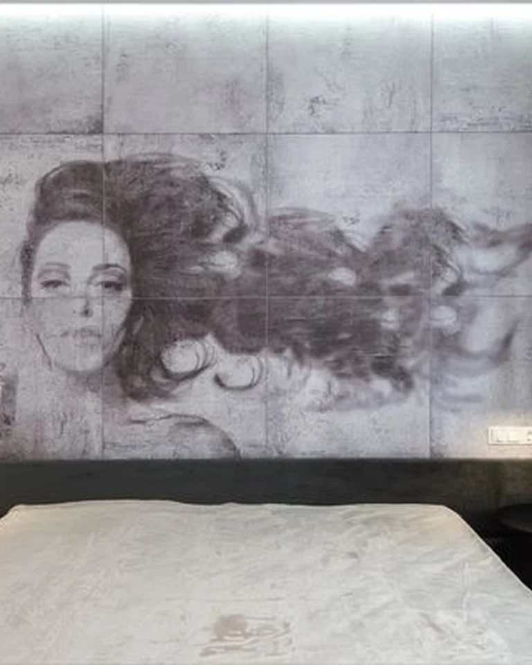 A bedroom with a large-scale mural art piece behind the bed
