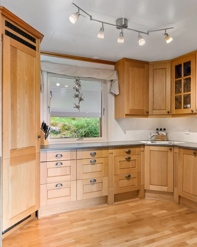 Pale maple kitchen cabinets with white walls