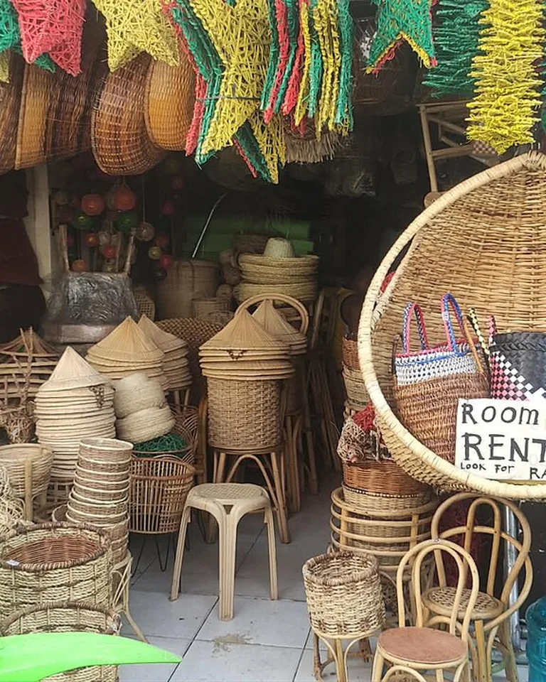 Handcrafted wicker and rattan baskets, chairs, and decor goods on display