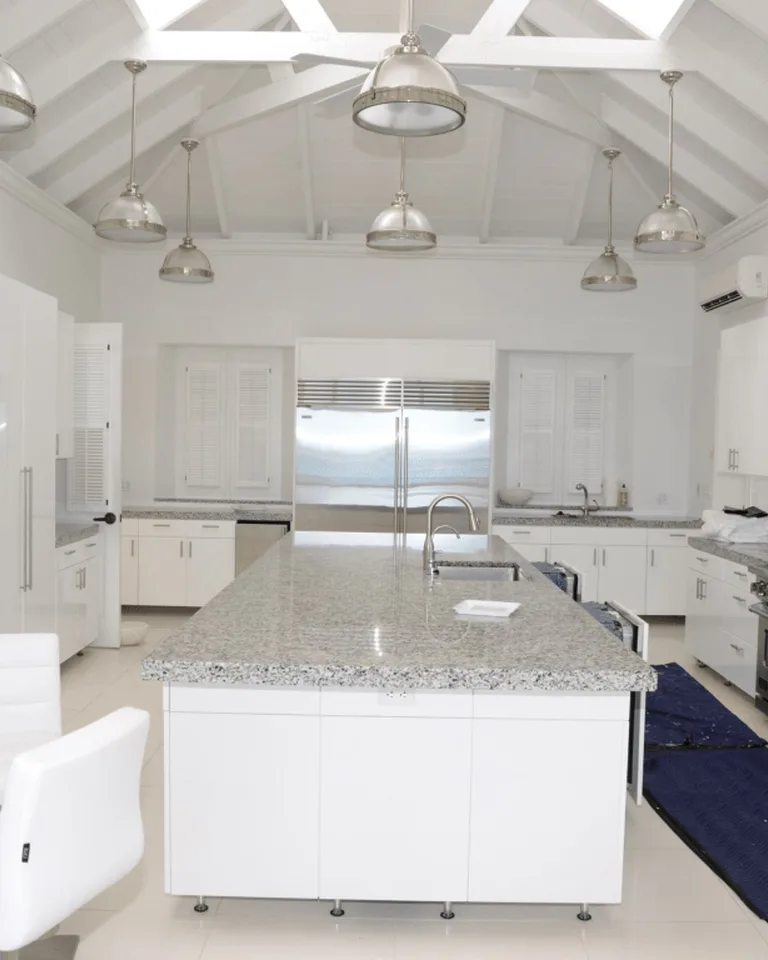 Modern white kitchen with a granite island