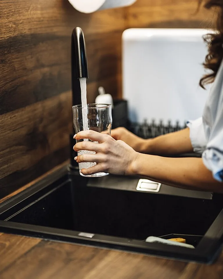 Matching soap dispensers corralled on a tray by the sink
