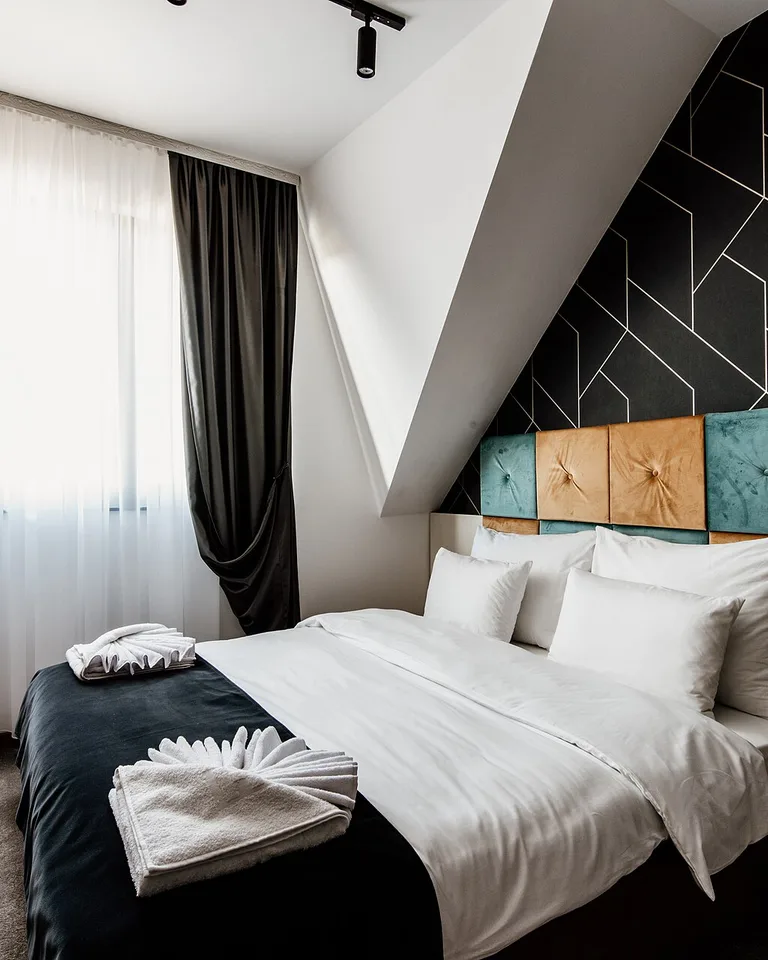 Bedroom with tonal pinstripe peel-and-stick wallpaper in soft gray adding height to the walls