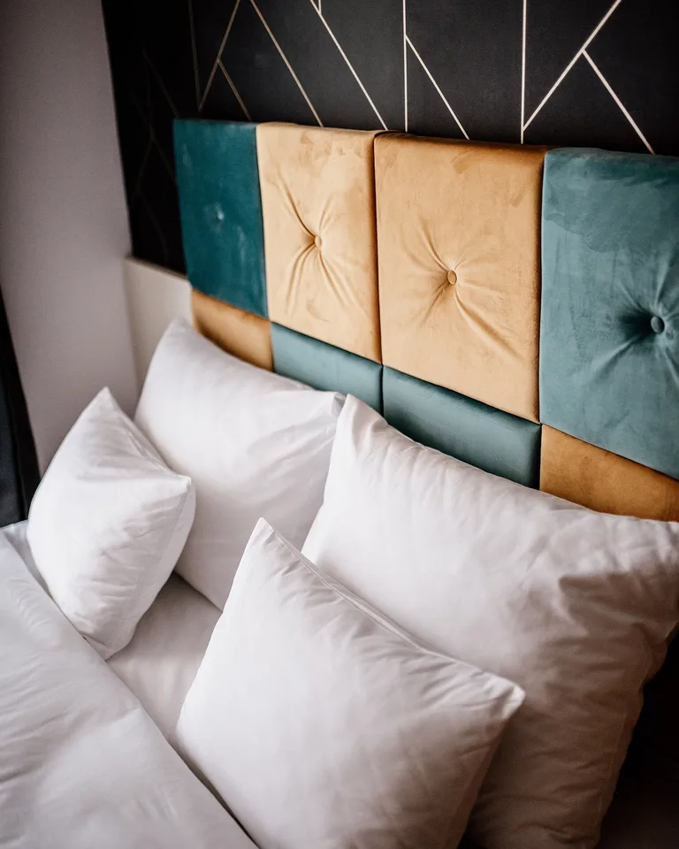 Calm Scandinavian-style bedroom with subtle boucle-dot textured peel-and-stick wallpaper
