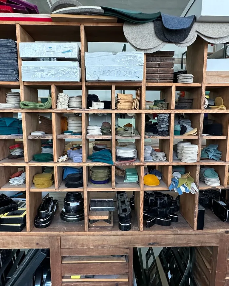 Organized craft supplies arranged on wooden shelves