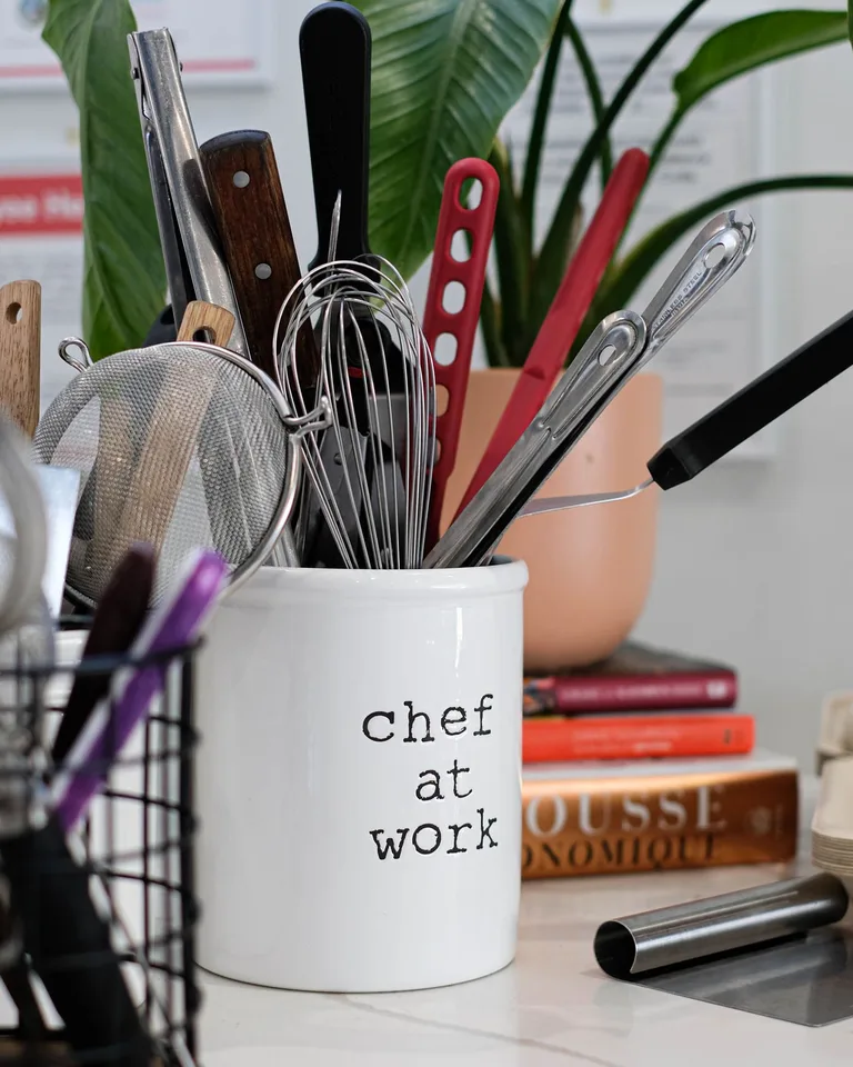 Kitchen utensil holder with a mug and spoon
