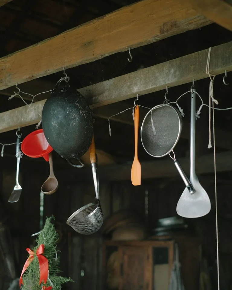 Rustic kitchen utensils hanging on hooks