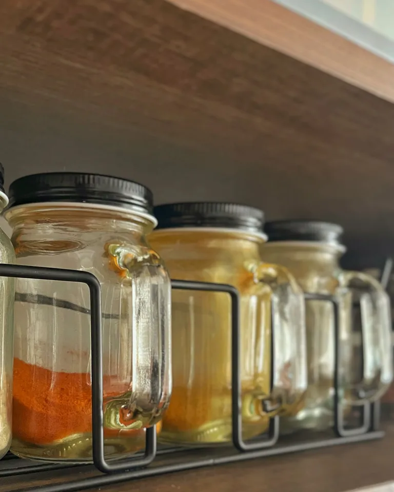 Glass jars arranged on a spice rack