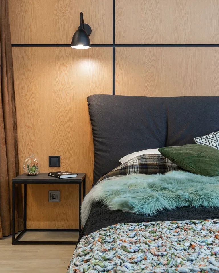 Bedroom with layered lighting from ceiling, sconces, and lamp