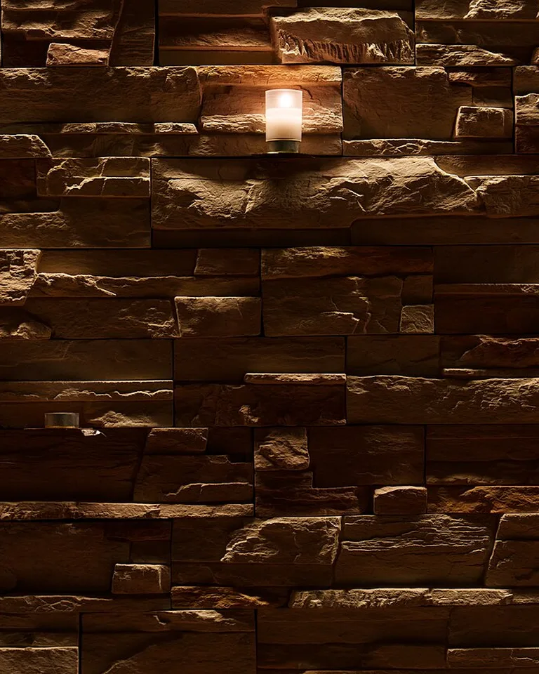 Candle decorations glowing on an interior stone wall