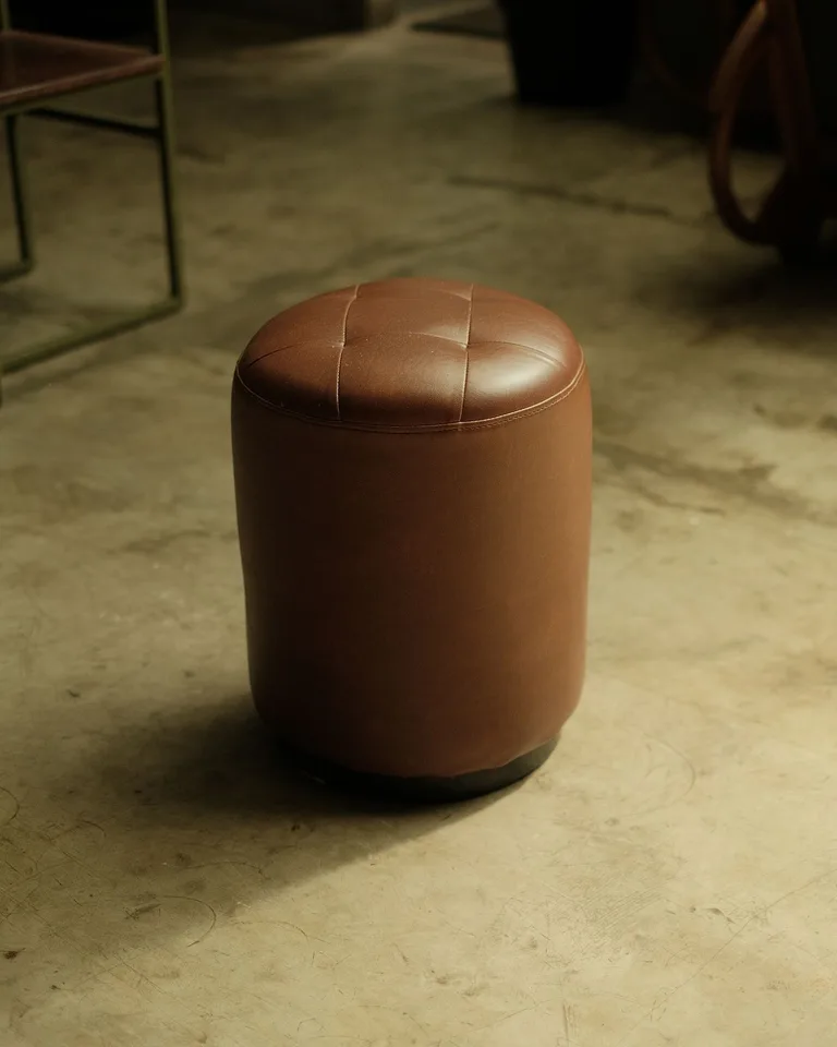 Round cognac-brown leather pouf ottoman