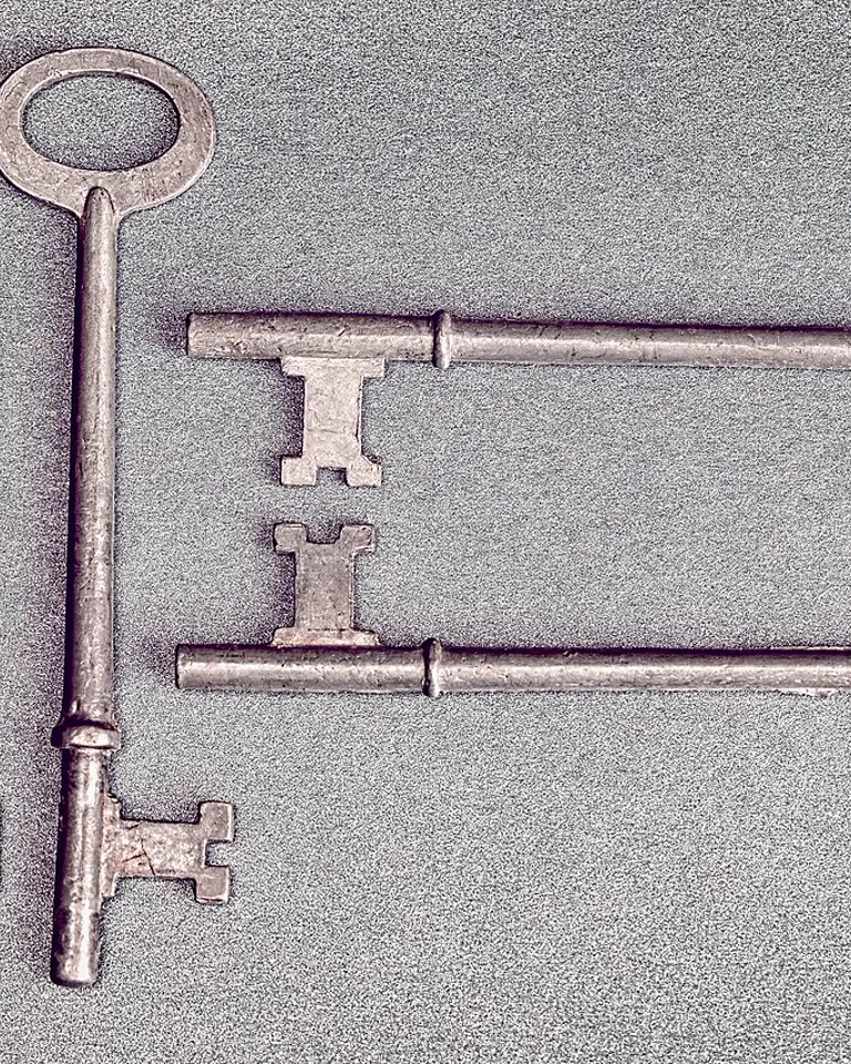 Vintage skeleton keys arranged on a blue background