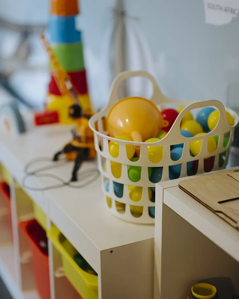 Rolling storage cart with bins for shared toys