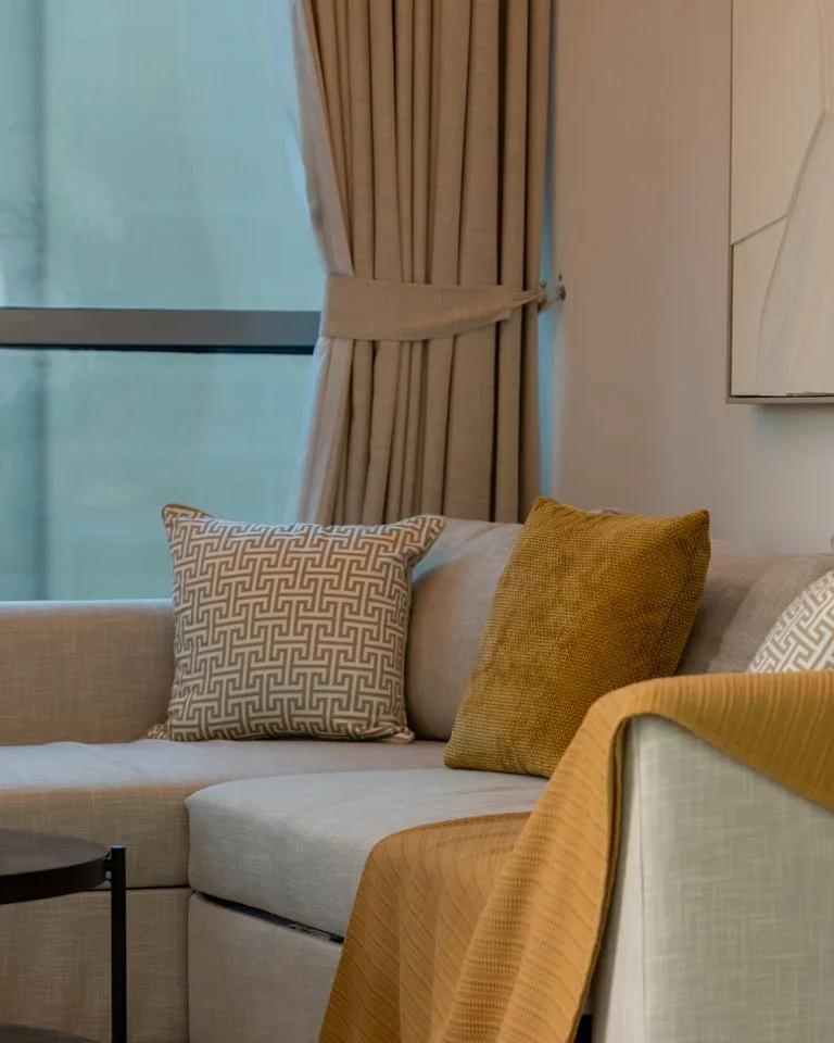 Cozy small apartment interior with layered textiles and soft light