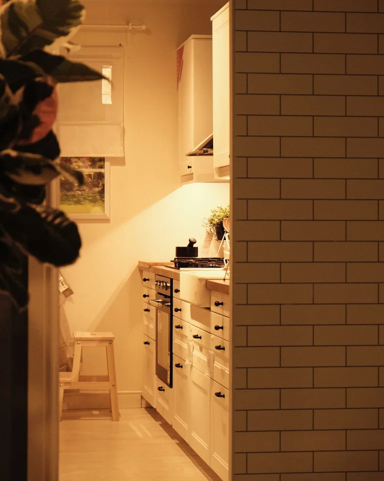 Compact kitchen with light cabinets and open shelving