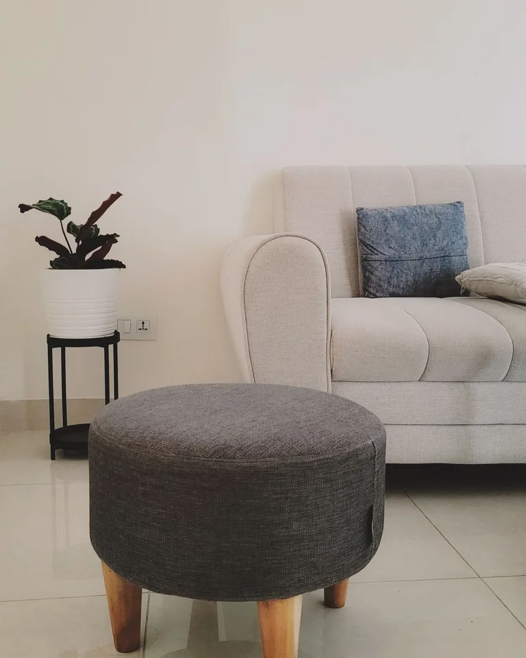 Storage ottoman doubling as a coffee table in a living room