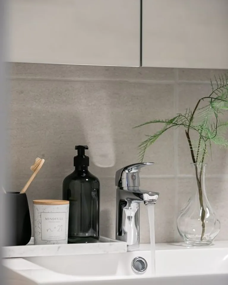 Styled bathroom accessories arranged on a vanity