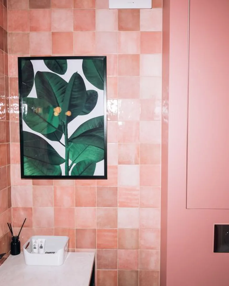 Small bathroom with deep green painted walls and matching vanity