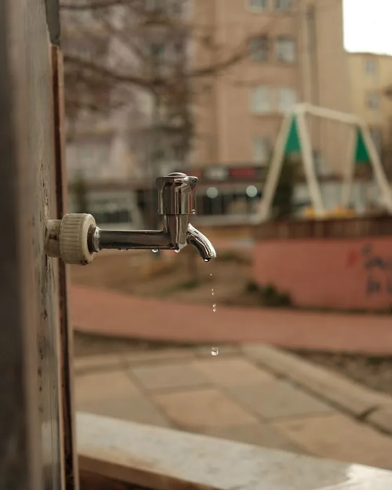 Close-up of a matte black bathroom faucet on a white sink