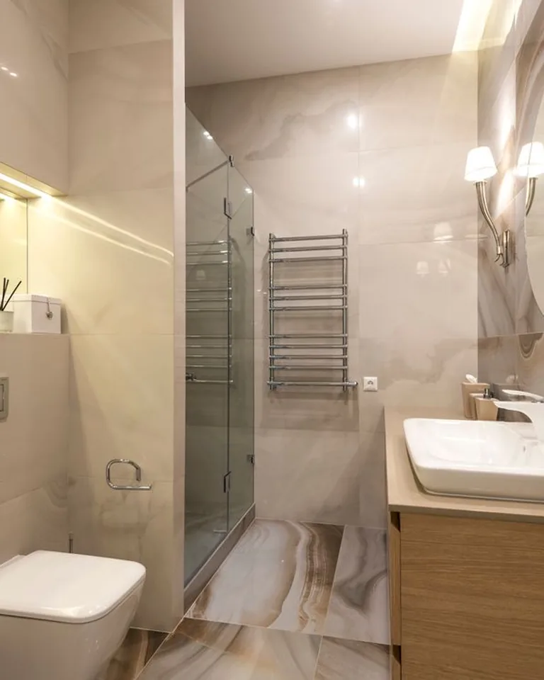 Vanity light fixture glowing warm over a bathroom mirror