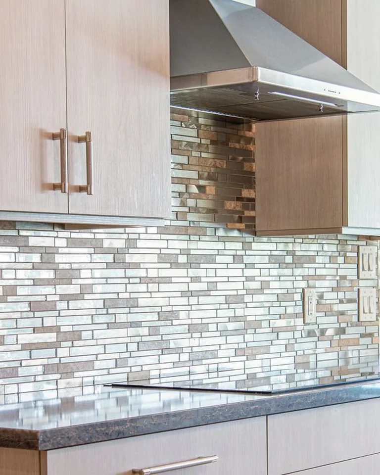 Patterned peel-and-stick tile backsplash behind a bathroom vanity