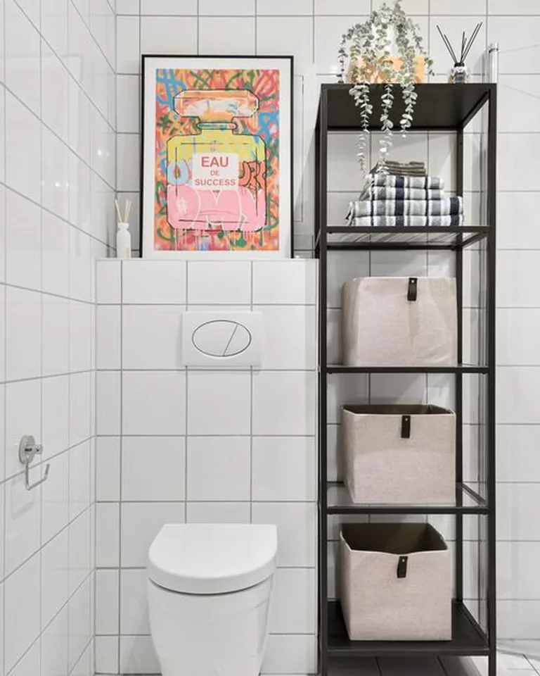 Floating shelves with baskets mounted above a toilet