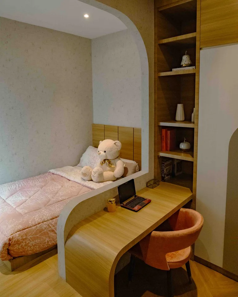 Compact desk tucked into the corner of a small bedroom as a workspace