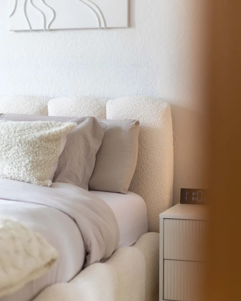 Cozy upholstered bed in a small bedroom