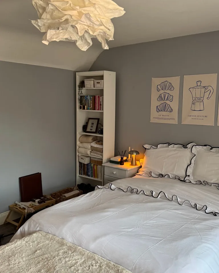 Cozy bedroom with a tall bookshelf and nightstand