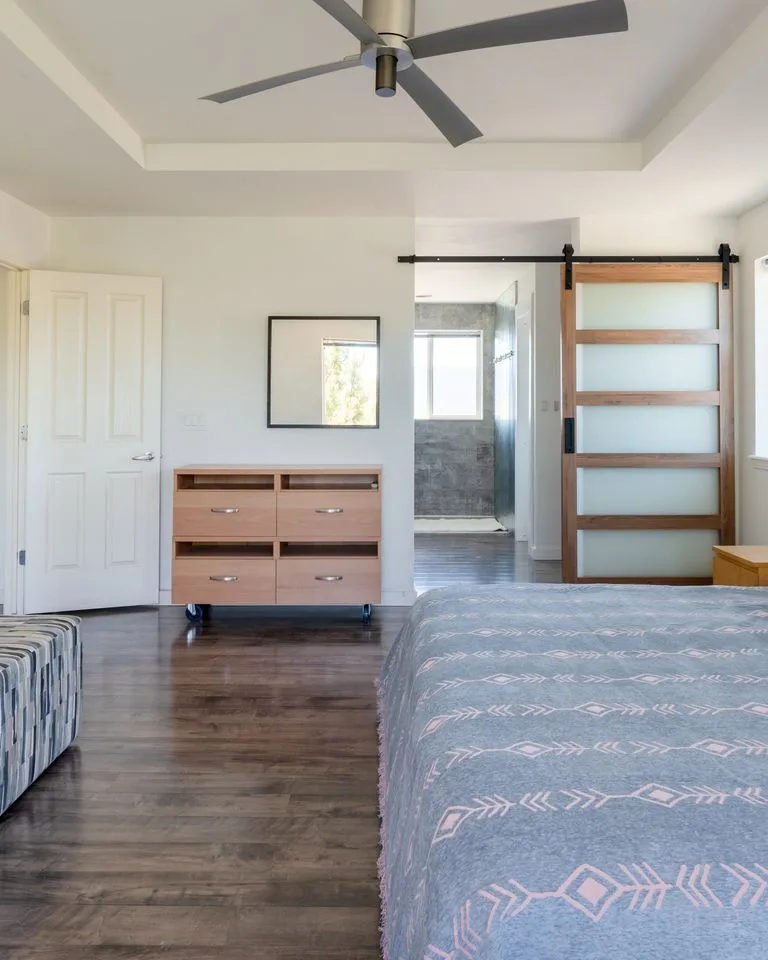 Bedroom with a low rolling dresser showing visible floor space