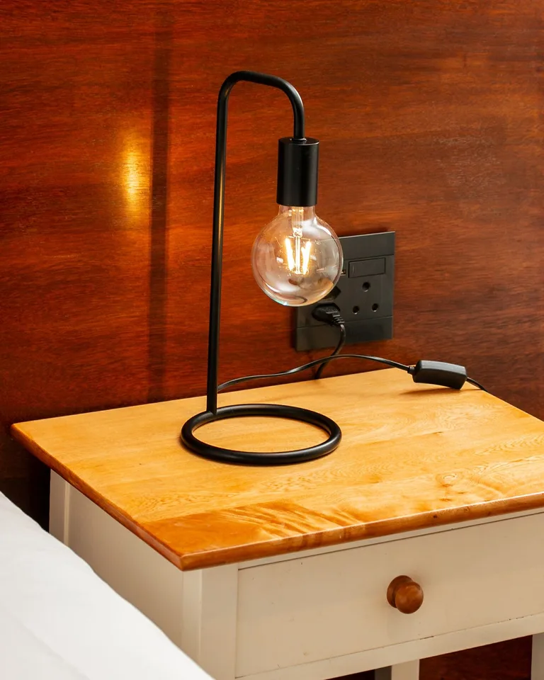 Stylish bedside table with a modern lamp and a drawer