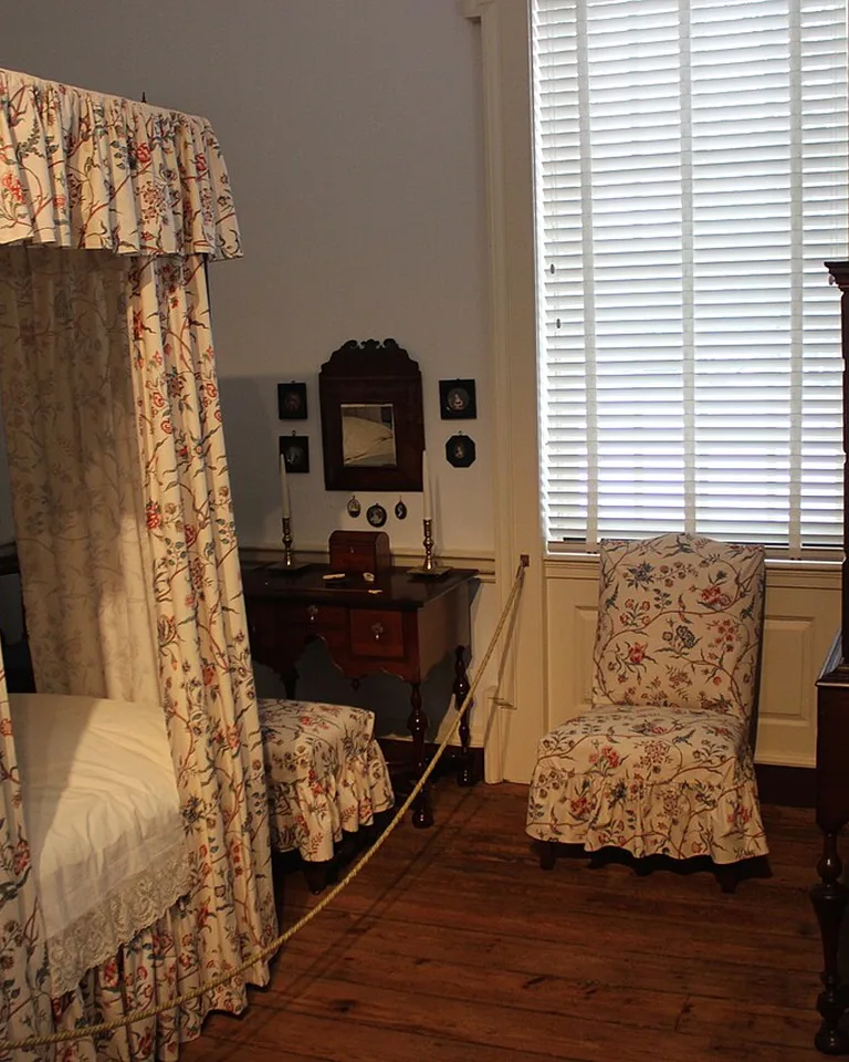 Bedroom with long fabric curtains around the bed