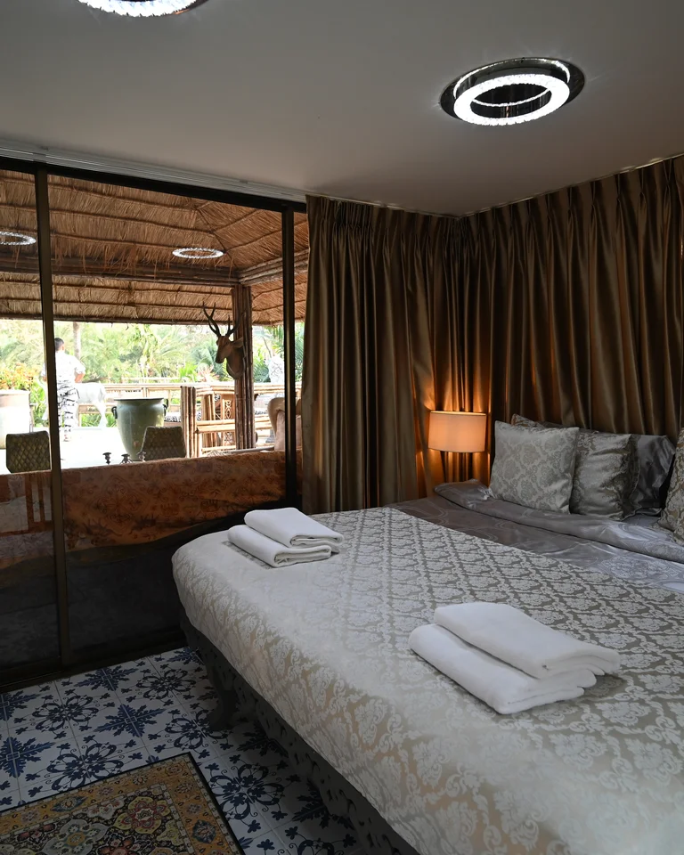 A cozy bedroom glowing with soft ambient lighting beside a bed