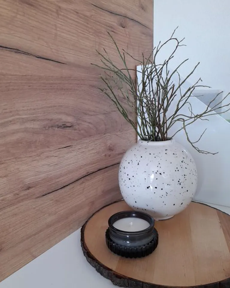 Decorative tray holding a candle and small items on a dresser