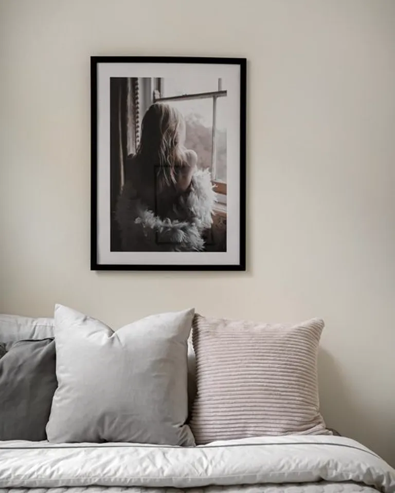 Single framed photo and keepsake displayed on a dresser