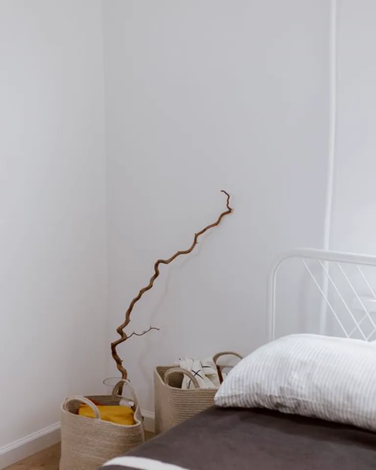Woven basket and folded textile on a dresser top