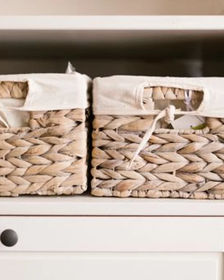Woven storage baskets with liners and small tags on a shelf