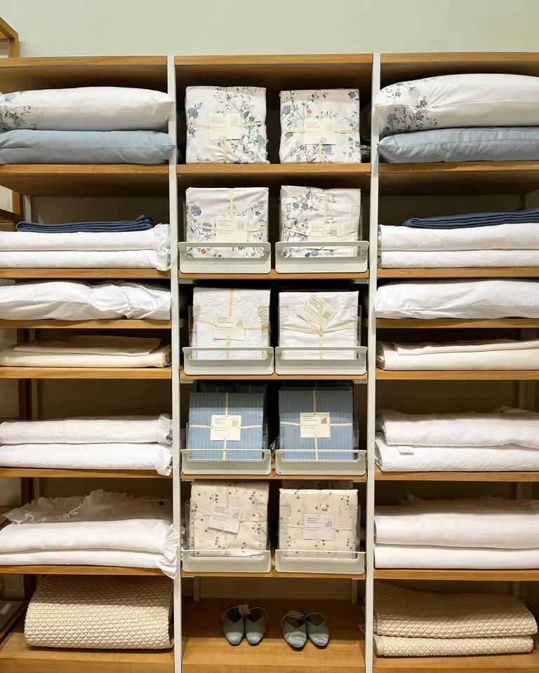 Neatly folded bedding and linens organized on shelves