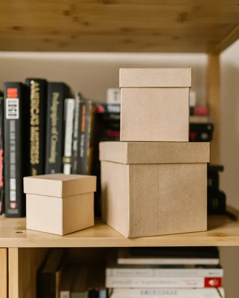 Matching kraft storage boxes stacked on a wooden shelf