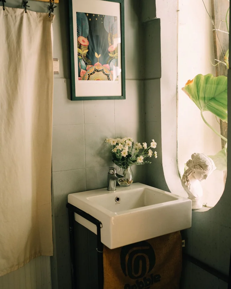 Compact bathroom with soft sage green painted walls and white fixtures