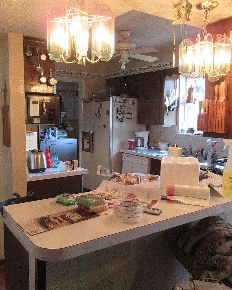 Warm traditional kitchen interior with wood cabinetry and white walls